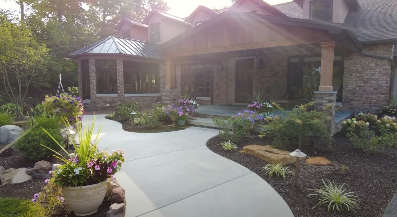 Professional landscaping services in Delano, CA showing beautiful curved walkway and stone accents